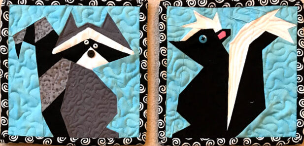 A raccoon and skunk made from fabric.